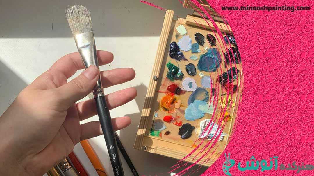 تصویر فردی در حال نگه داشتن قلم نقاشی